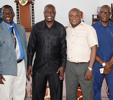 Four men standing together for a photograph
